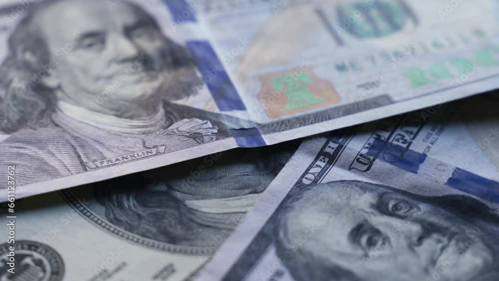 Hundred dollar bills are spinning on the table. Close-up. Business and finance concept. Hundred dollar bills are spinning on the table. Close-up. Business and finance concept.