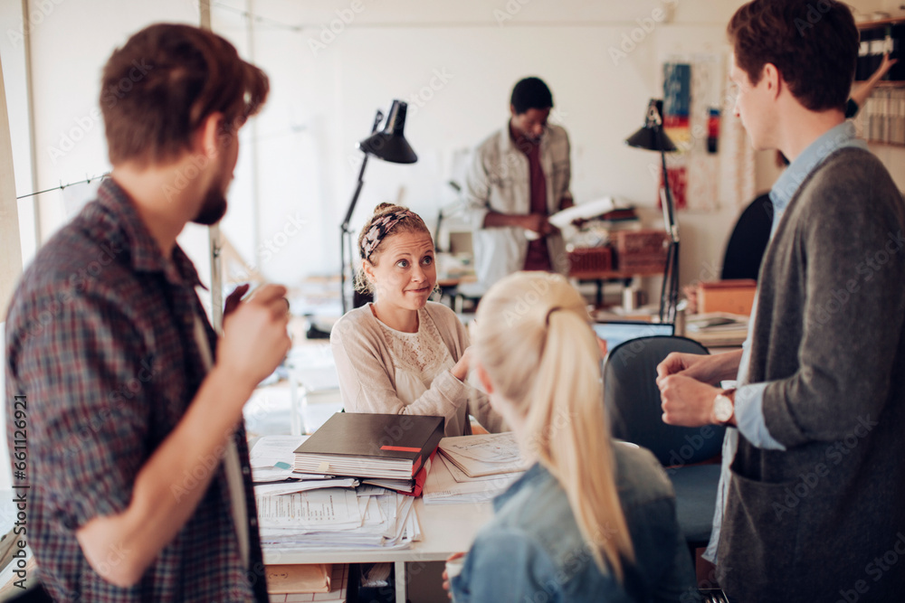 Obraz premium Young and diverse group of architects working on a project together in a startup company office