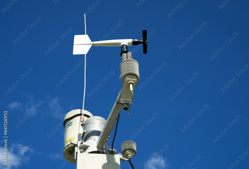 White weather station against a blue sky, meteorology White weather station against a blue sky, meteorology