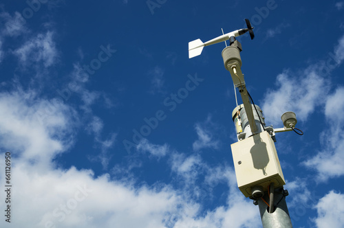 White weather station against a blue sky, meteorology