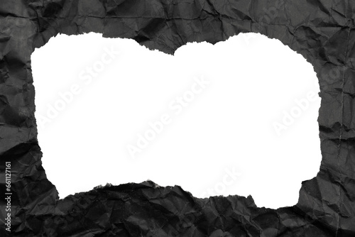 Black paper background with copy space. Hole on a crumpled dark sheet