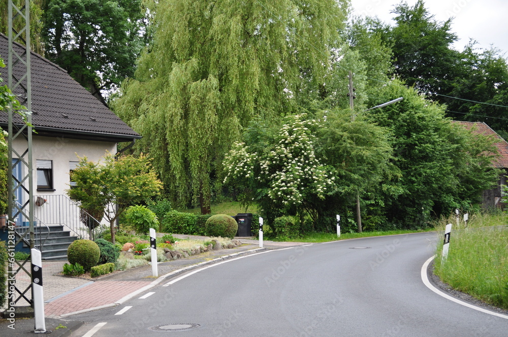 view of part of the street with a road, house, garden view of part of the street with a road, house, garden