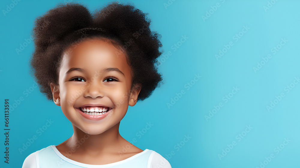 Close-up of a smiling African American little girl with white perfect teeth, isolated on a blue studio background with copy space. Children's Dental Care. Dentistry concept. Close-up of a smiling African American little girl with white perfect teeth, isolated on a blue studio background with copy space. Children's Dental Care. Dentistry concept.