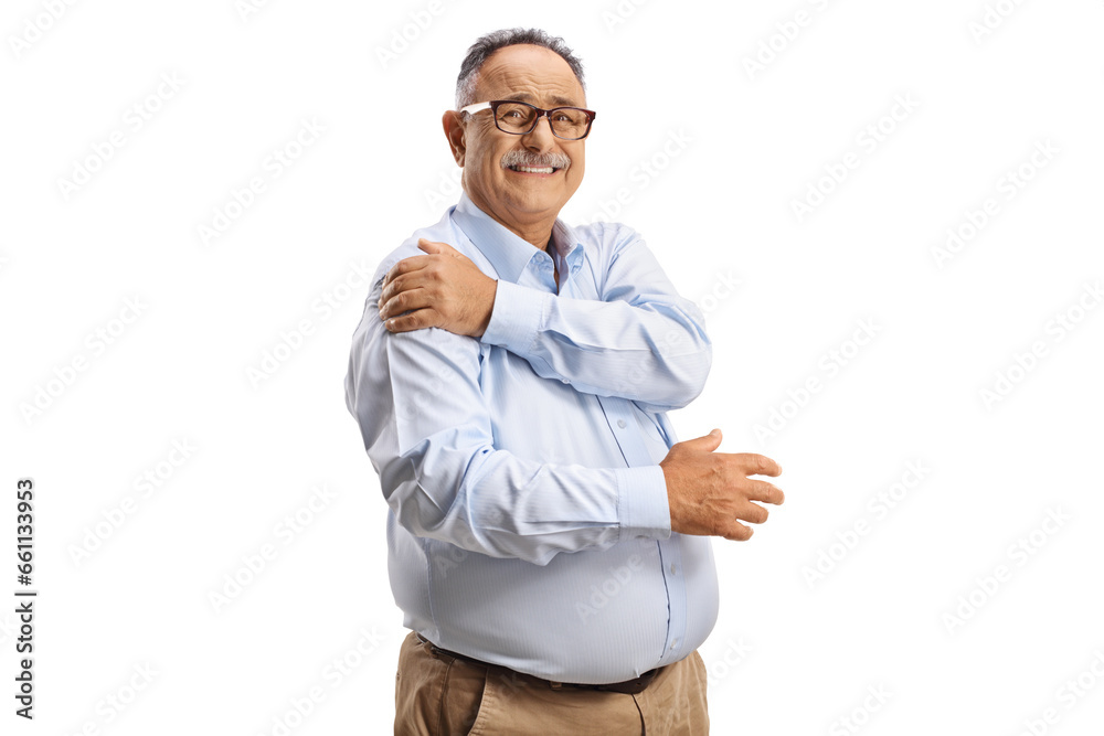 Mature man holding his painful shoulder and looking at camera Mature man holding his painful shoulder and looking at camera