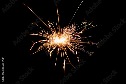 Sparklers on black isolated background. Sparks from a burning sparkler. To insert an image in a blend mode © Volodymyr
