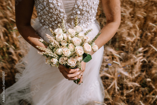 Photography The bride is holding her wedding bouquet, a symbol of beauty and love, in her ha