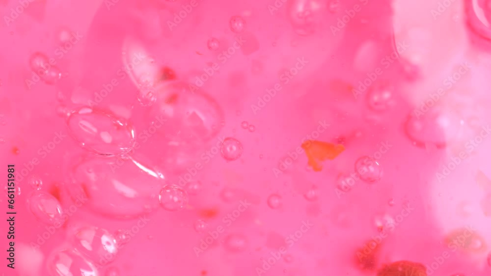 Pink cosmetics product with bubbles. Pink shower gel rotation. Pink cosmetics product with bubbles. Pink shower gel rotation.