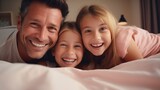 Father and children laughing in bed