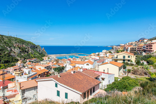 view from the top of the hill onto a beautiful and picturesque town Buggerru, Sardinia, Italy lying on the seashore of Mediterranean sea