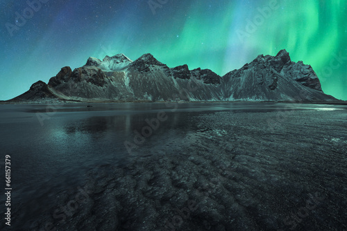 Water and mountain during northern lights photo