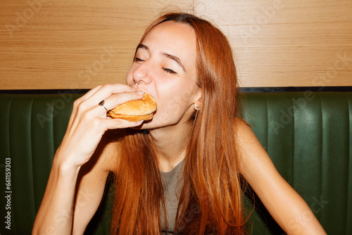 Young woman enjoy eating hamburger