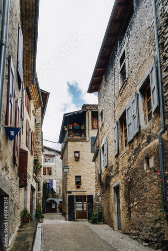 Fototapeta Naklejka Na Ścianę i Meble -  Narrow street and old house stone facades with shutters in the medieval village of Chatillon en Diois, in the south of France (Drome)