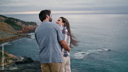 Romantic family standing beach in front evening seascape. Loving couple hugging.