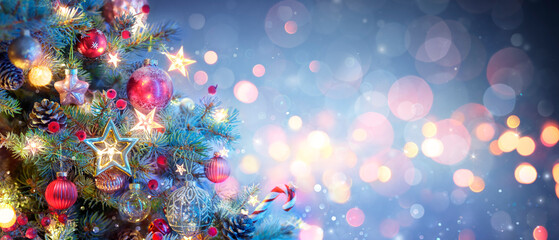 Christmas Tree With Ornaments In Blue - Baubles Hanging On Fir Branches With Glittering And Bokeh Lights In Abstract Defocused Background