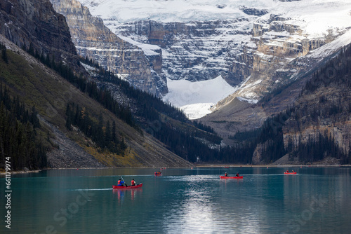 Beautiful landscape, Red Small Boats on Lake Louise, White Snow Mountain in Banff National Park, Canada
