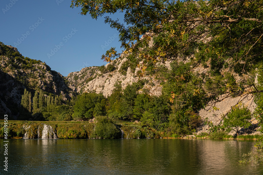 Fototapeta premium Landscape with small waterfall on a Krupa river inside of a deep valley