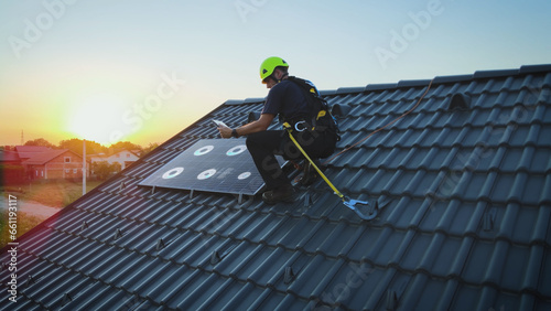 Solar panel engineer installing a photovoltaic cell on a house roof - VFX render