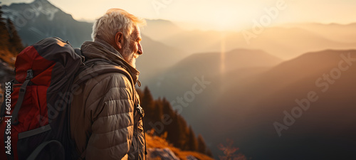 old man climbing a mountain reaching the top - concept - age does not matter