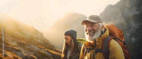 elderly couple climbing a mountain reaching the top - concept - age does not matter photo