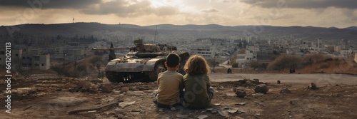 kids sitting in front of city burned destruction of an war invasion conflict, military tank fire and smoke of political world war against children innocence concept as banner with copyspace photo