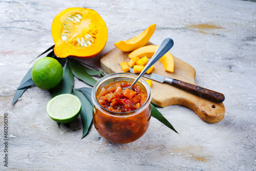 Traditional Indian pumpkin chutney with lemon and ginger served as close-up in a design bottling jar photo