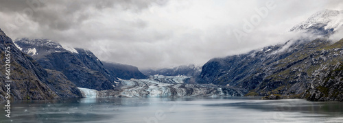 panorama of glacier with clouds, mist rocks and ice