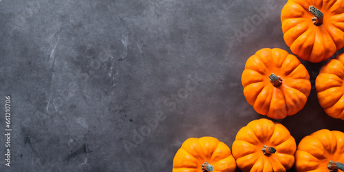 Orange pumpkins seen from above on gray background
