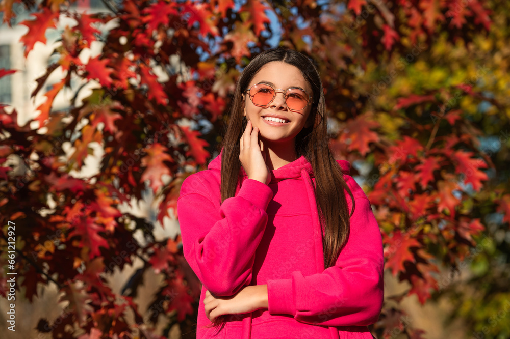 Girl in autumn style outdoor. Fall style fashion. Autumn leaves and happy young girl in forest. The color and mood of autumn. Teenager girl in the autumn park. Fall concept. Seasonal change Girl in autumn style outdoor. Fall style fashion. Autumn leaves and happy young girl in forest. The color and mood of autumn. Teenager girl in the autumn park. Fall concept. Seasonal change