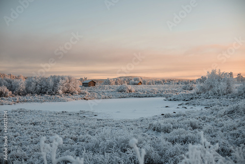 Frozen landscape during sunset with house and lake.jpg photo