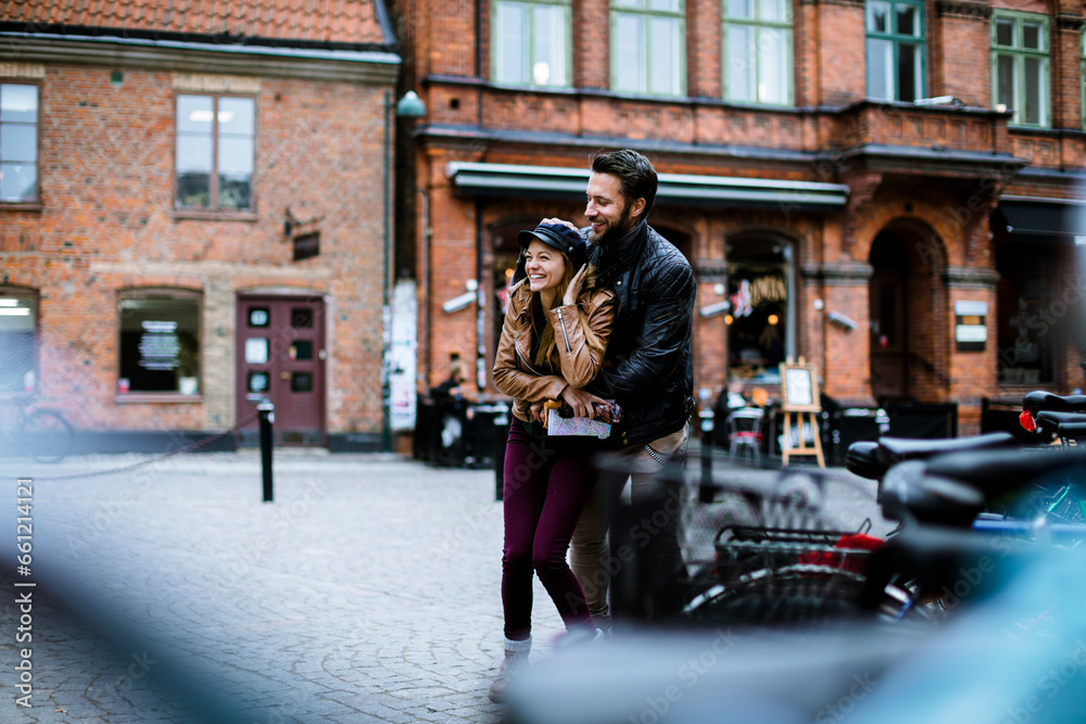 Young loving couple embracing each other during a walk in the city
