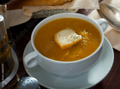 Appetizing vegetable soup puree served with cheese in bowl