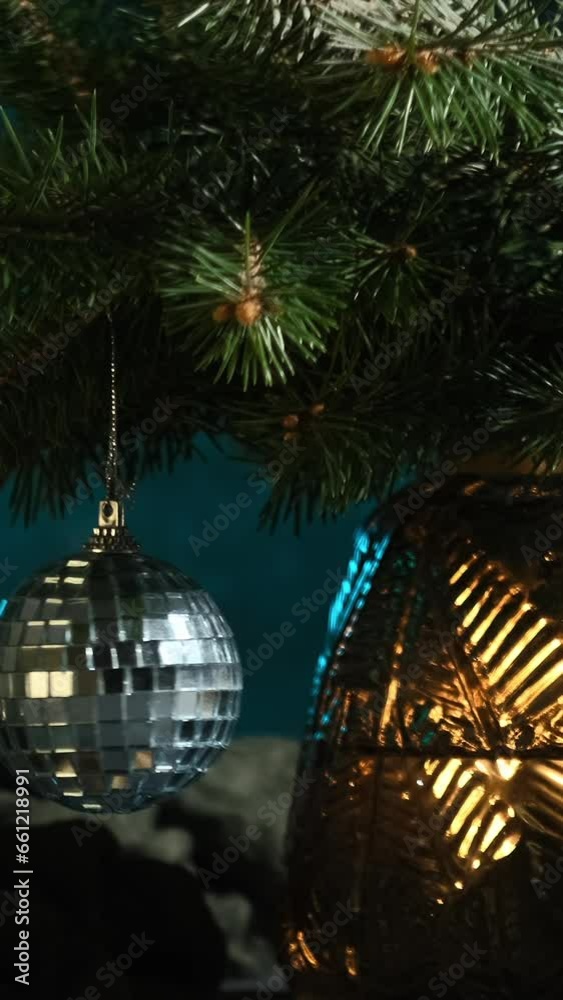 Vertical video. Christmas bauble hanging on Christmas tree branch. Cosy Xmas home decor.