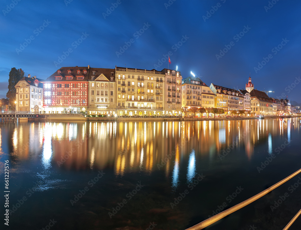 Beautiful historic city center of Lucerne with famous buildings and promanade during night..