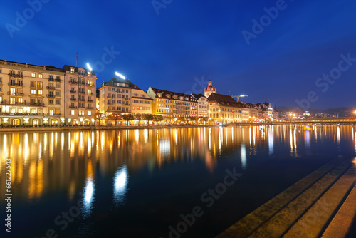 Beautiful historic city center of Lucerne with famous buildings and promanade during night..