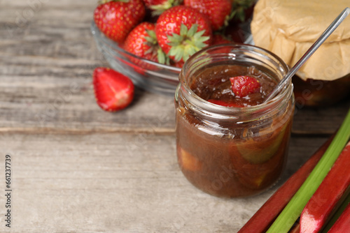 Wallpaper Mural Tasty rhubarb jam, stems and strawberries on wooden table. Space for text Torontodigital.ca