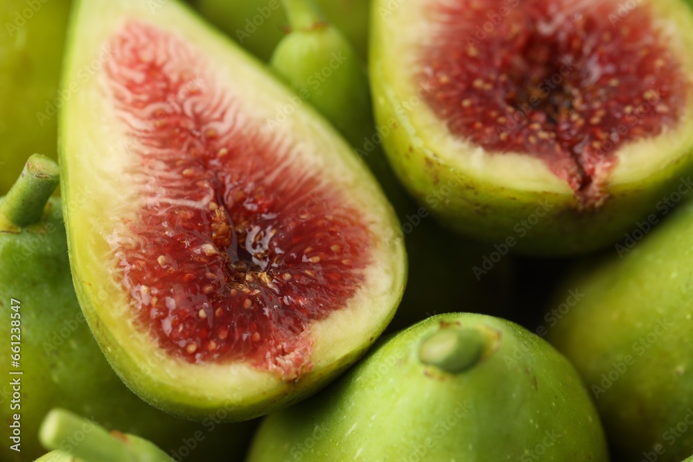 Cut and whole fresh green figs as background, closeup view