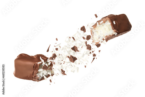 Broken chocolate bar with shredded coconut in air on white background