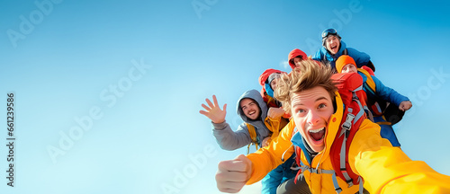 Young overjoyed friends group taking selfie pic in winter sports outfit isolated on a blue sky background - Happy college students having fun together on the mountain - Friendship concept photo