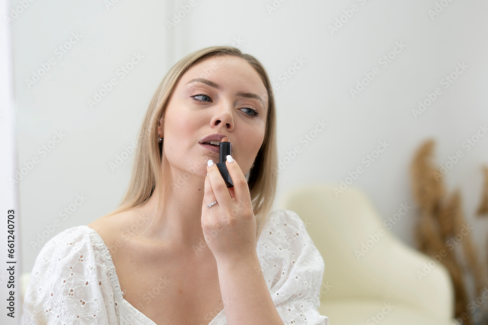 girl's daily routine. white female applying lipstick and painting lips at home girl's daily routine. white female applying lipstick and painting lips at home