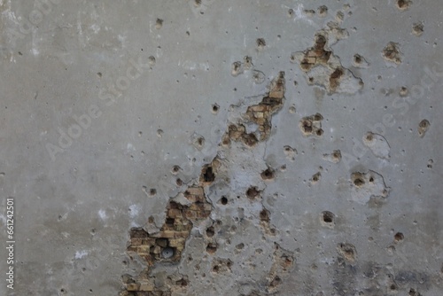 Bullet and mortar holes damage the building facade 