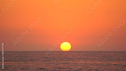 The big sun touches the water. Beautiful sea sunset