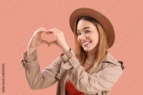 Young woman making heart wi...