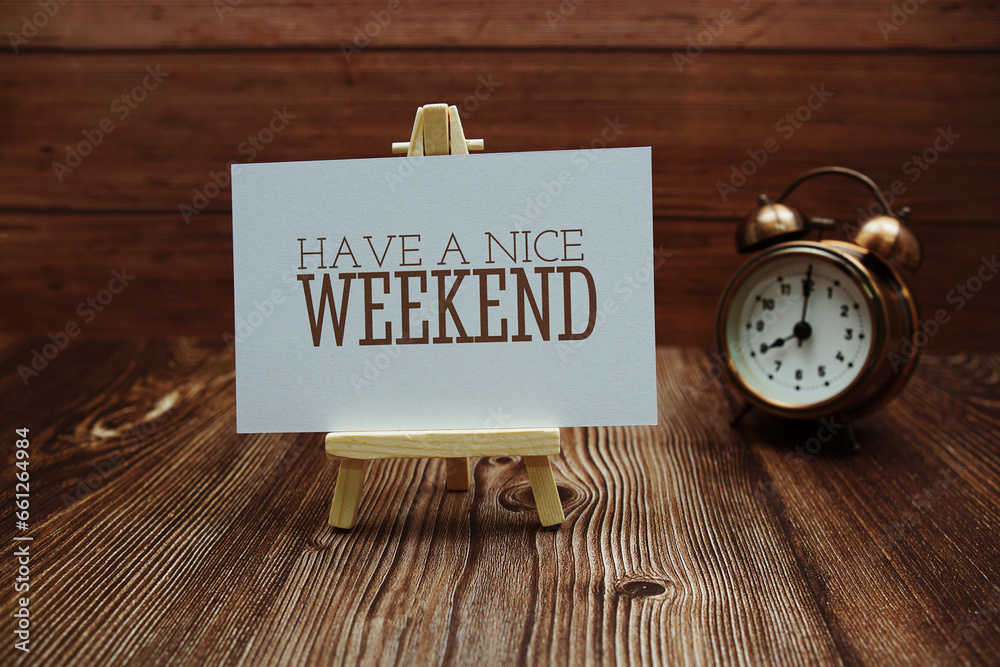 Have a nice weekend text on paper card on wooden background Have a nice weekend text on paper card on wooden background