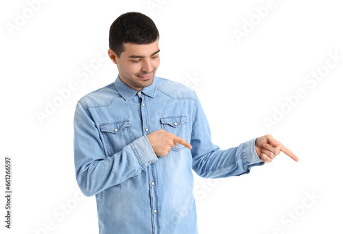 Young man pointing at somet...