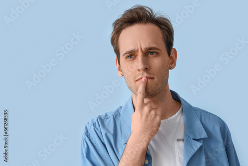 Thoughtful young man on blu...