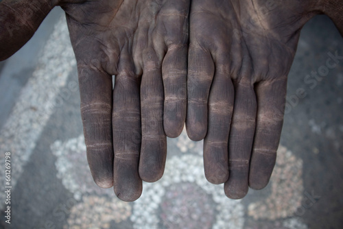 Dirty hands of a man working iron