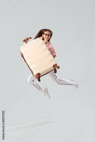 Little girl with suitcase j...