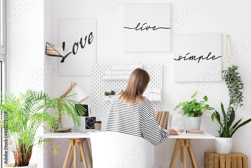 Young woman working at desk...