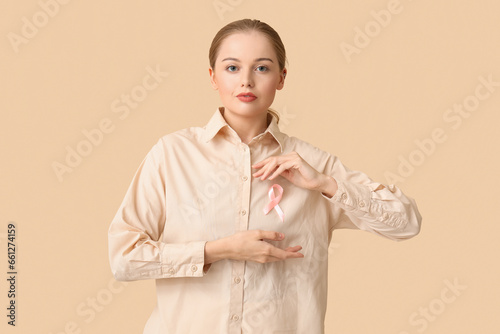 Young woman with pink ribbo...
