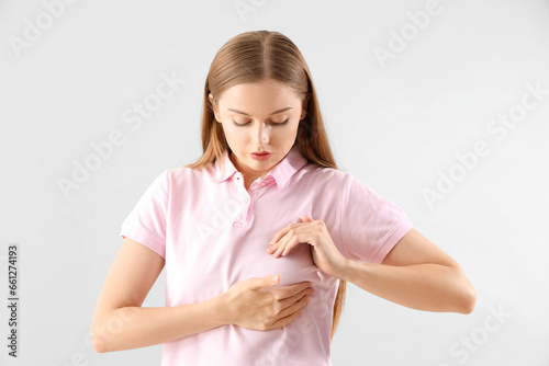 Young woman on light backgr...